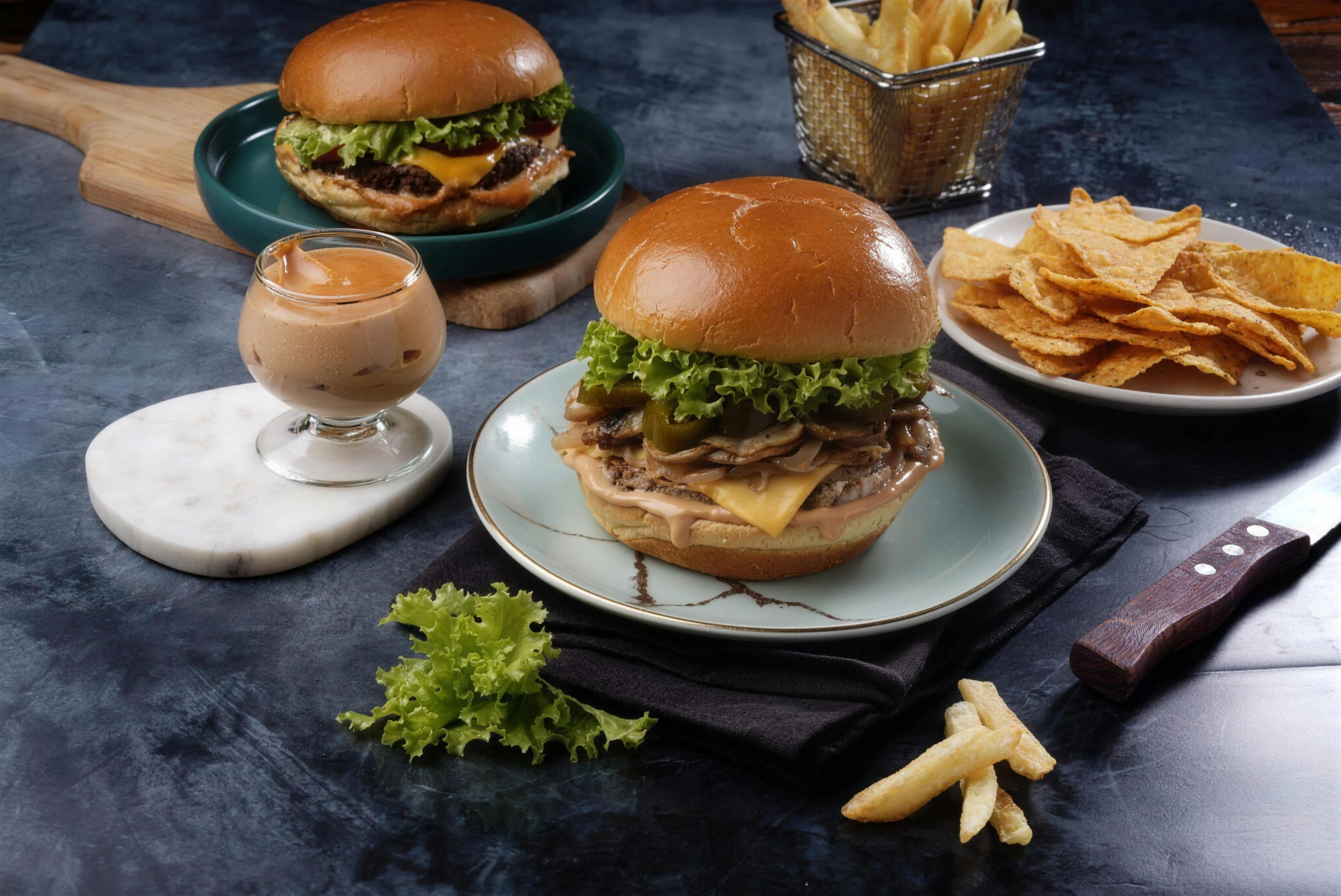 A spread of gourmet burgers and fries.